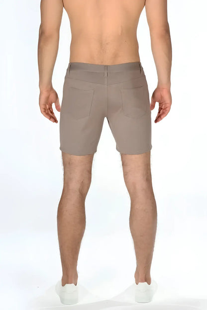 Beige stretch knit shorts with tailored fit and two rear pockets shown from the back side