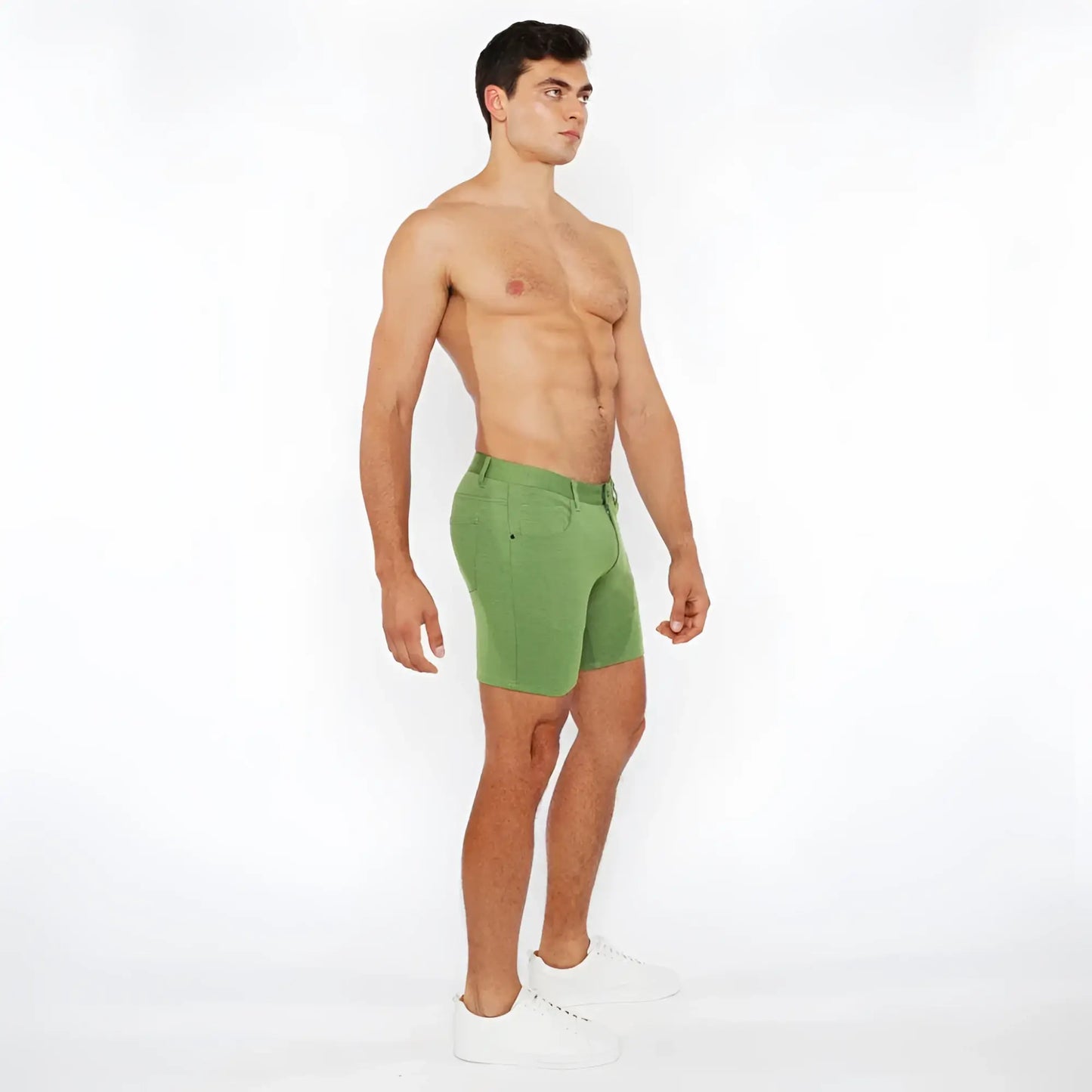 Green stretch knit athletic shorts with a fitted cut and visible stitching details for active wear
