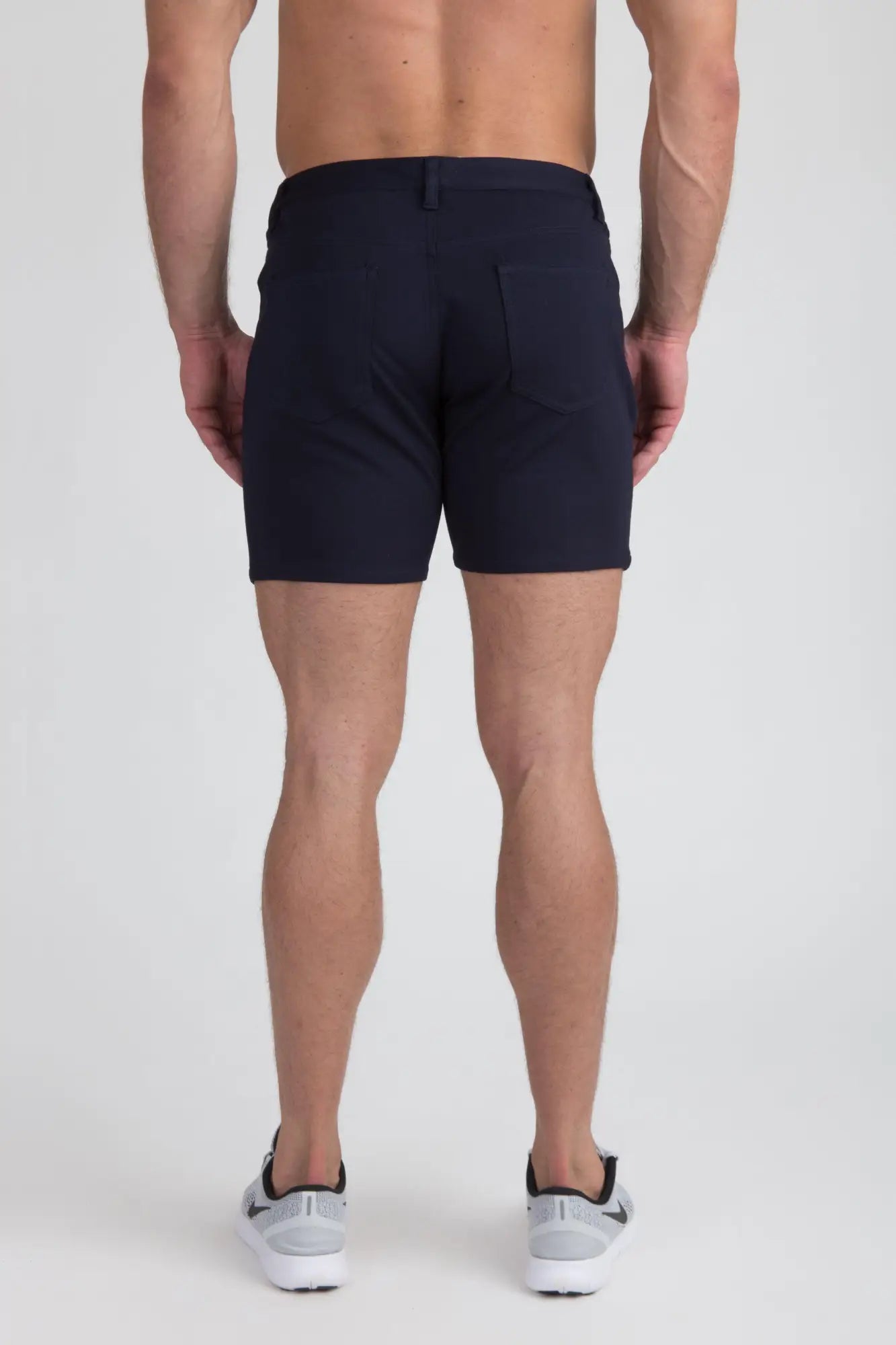 Navy blue stretch knit shorts with tailored fit and subtle stitching details for a sleek modern look