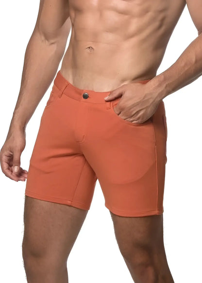 Orange stretch knit athletic shorts with button closure and side pockets for comfortable activewear use