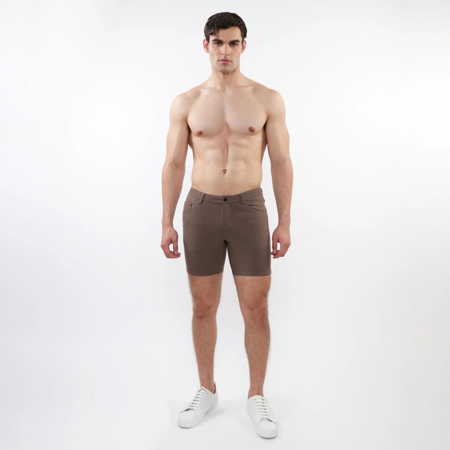 A pair of slim-fit dark brown stretch knit shorts with a modern design and subtle stitching details