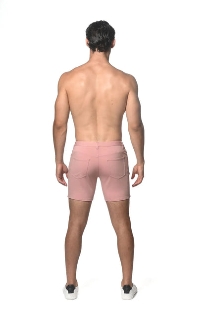 Pink stretch knit shorts shown from the back with two pockets and a zipper closure