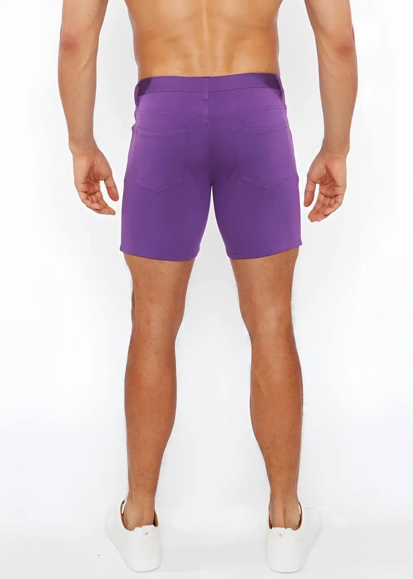 Purple stretch knit shorts with a straight-leg cut and two back pockets shown from the back side