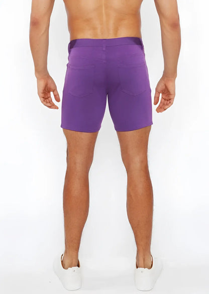 Purple stretch knit shorts with a straight-leg cut and two back pockets shown from the back side