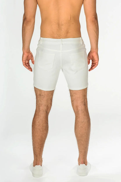 White stretch knit shorts in denim with a tailored fit and classic back pockets shown from the back side