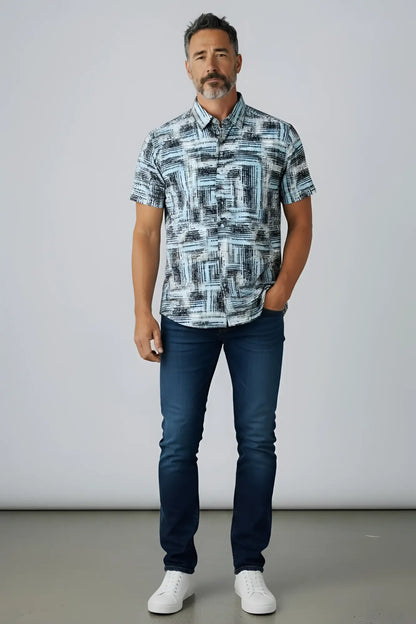 A man wearing a suslo crinkled fabric short-sleeved shirt with an abstract gray and white geometric pattern