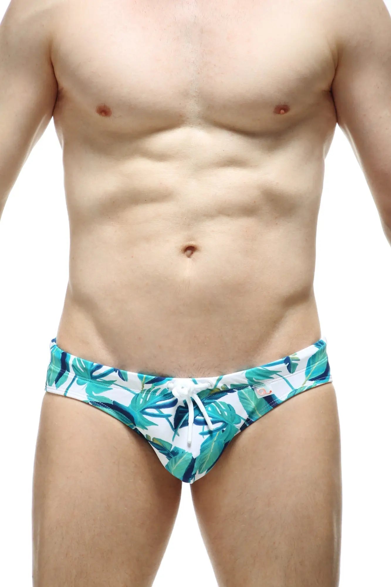 White swim trunks swim bikini macouba with teal and green tropical leaf pattern and white drawstring waistband