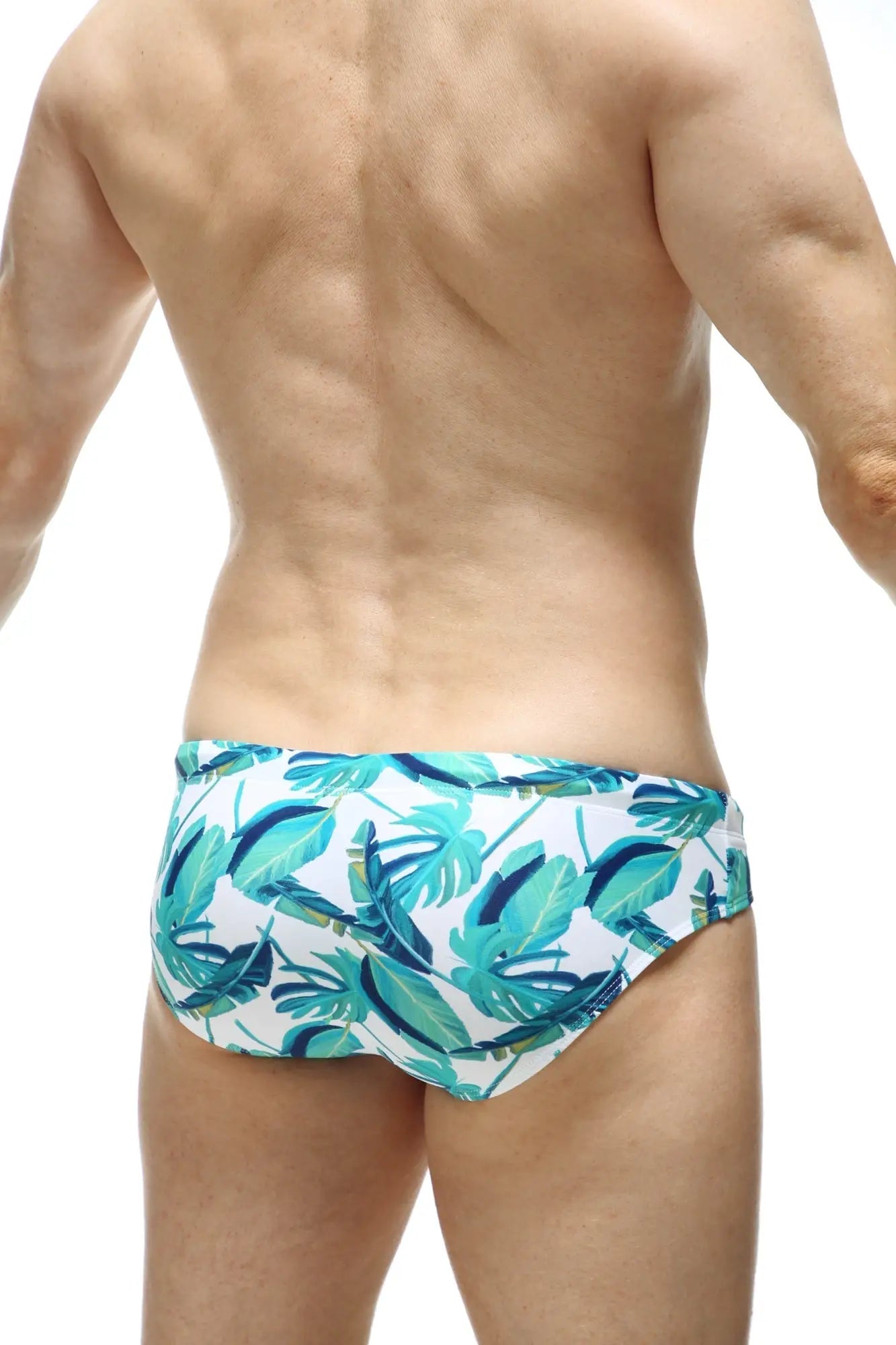 White swim trunks swim bikini macouba with vibrant teal and dark blue tropical leaf pattern for beachwear