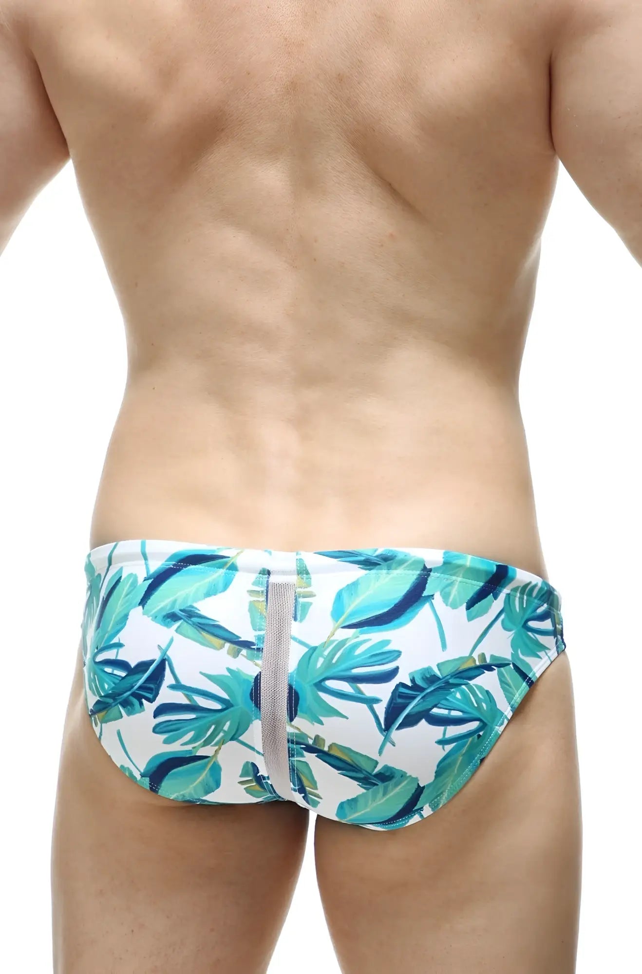 White swim bikini tarcu macouba swim trunks with vibrant teal and green tropical leaf pattern and central gray zipper