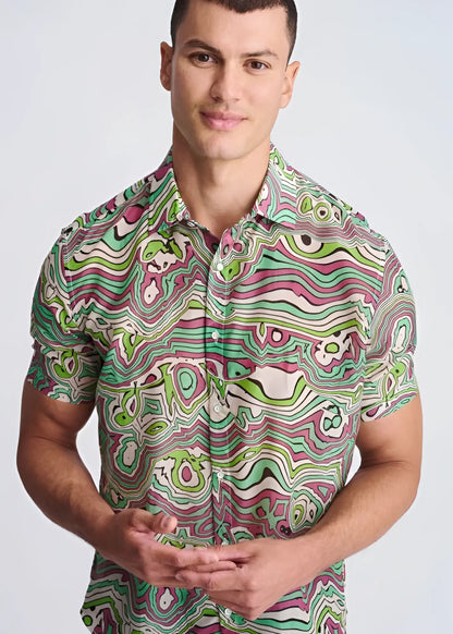 A vibrant short-sleeved lightweight cotton silk shirt with a psychedelic green pink and white swirl pattern