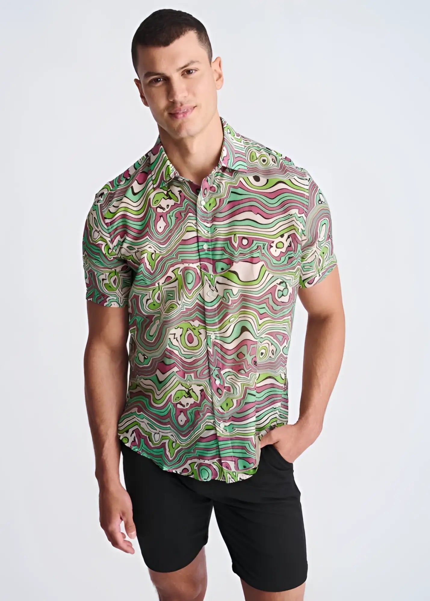 A vibrant short sleeved button up shirt with psychedelic green pink and white swirl pattern made from lightweight cotton silk