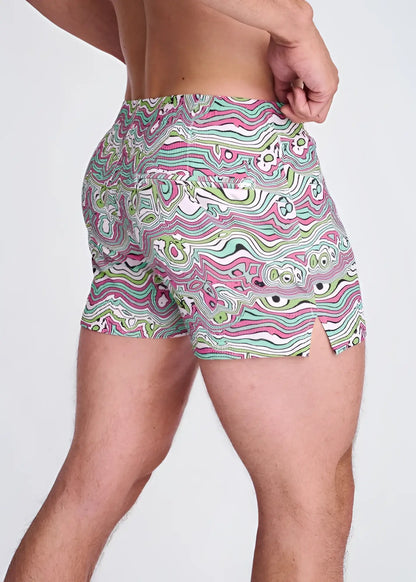 Swirls print seersucker swim shorts with mesh lining in vibrant pink green and white psychedelic wavy abstract pattern