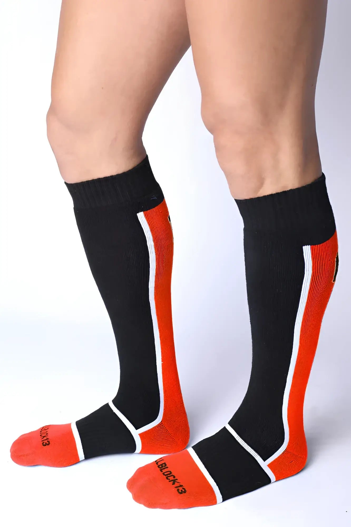 Take down knee high socks in black and orange with white trim ribbed texture and black & red logo on the foot