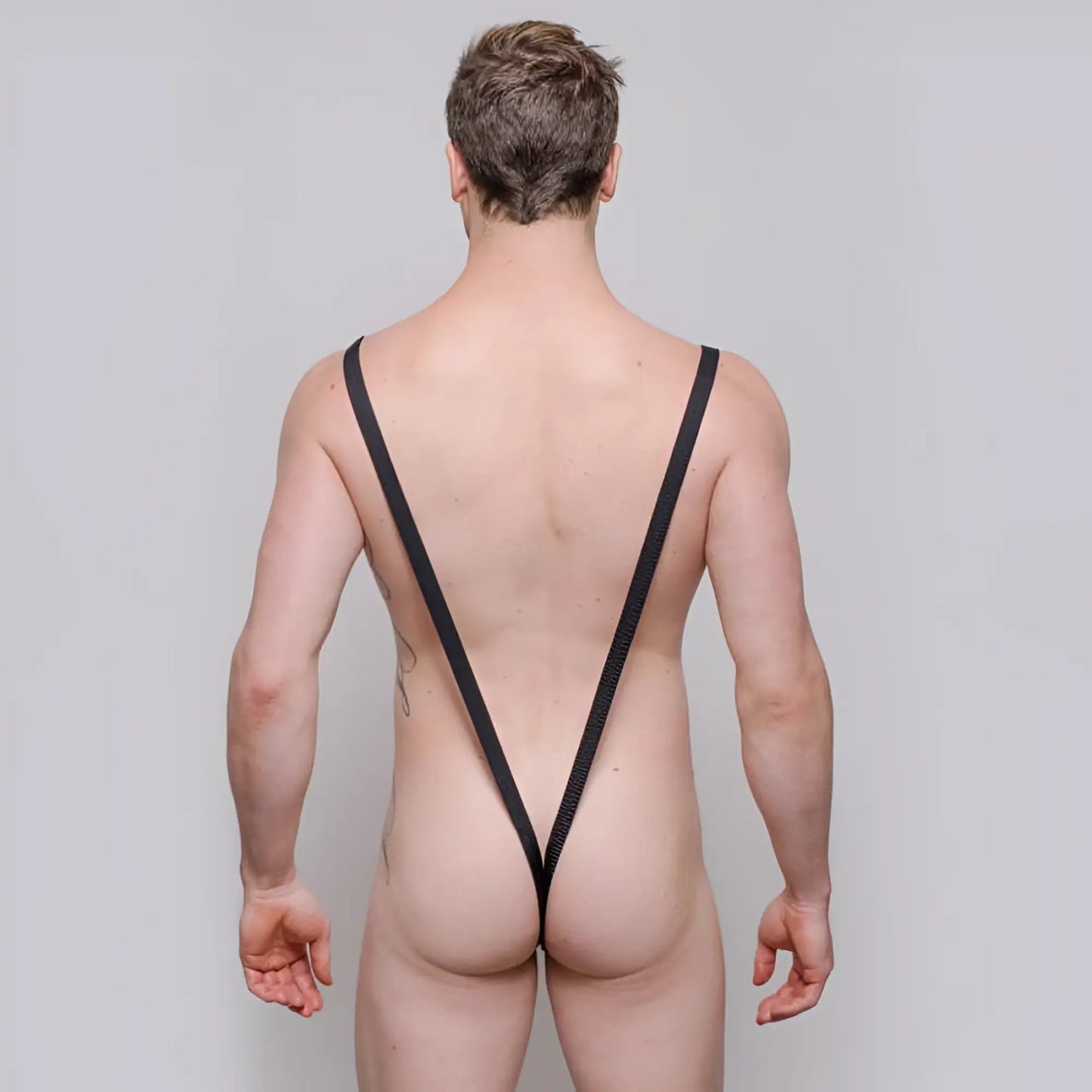 Black mesh strappy backless briefs with rings showing the back of tartarus sling shot body thong