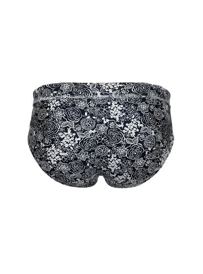 Black tartarus swim brief with delicate white and gray rose floral pattern designed for swimwear use