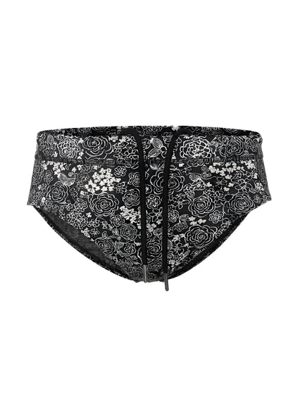 Black tartarus swim brief with white floral and bird pattern and drawstring waistband for beachwear