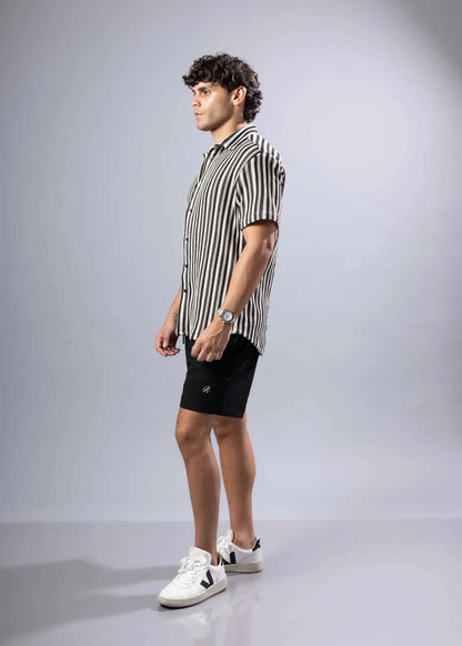 A man wearing a black and white vertically striped texture knit short-sleeved shirt product s s shirt