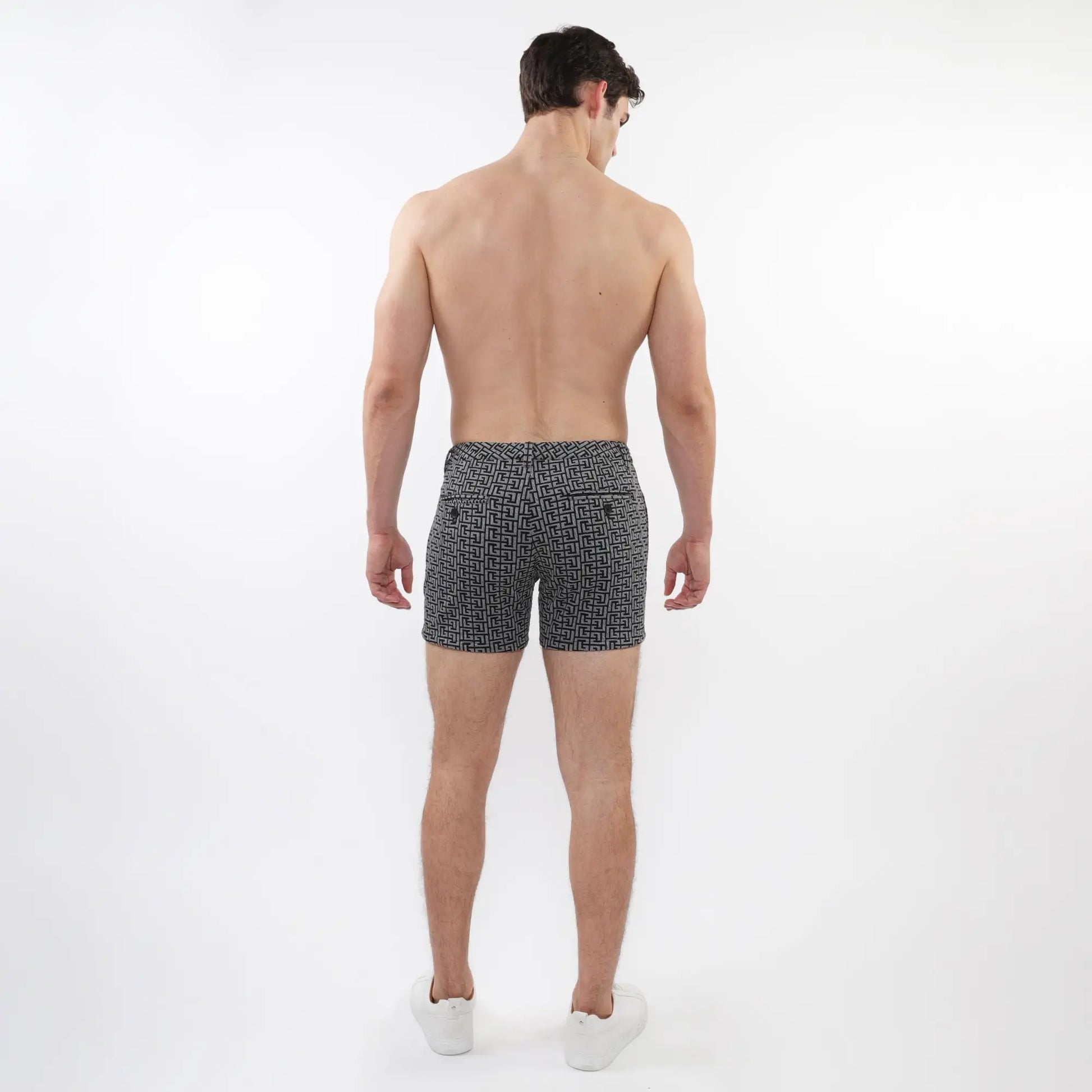 Black and white geometric patterned textured jacquard stretch knit chino swim trunks with zip pockets