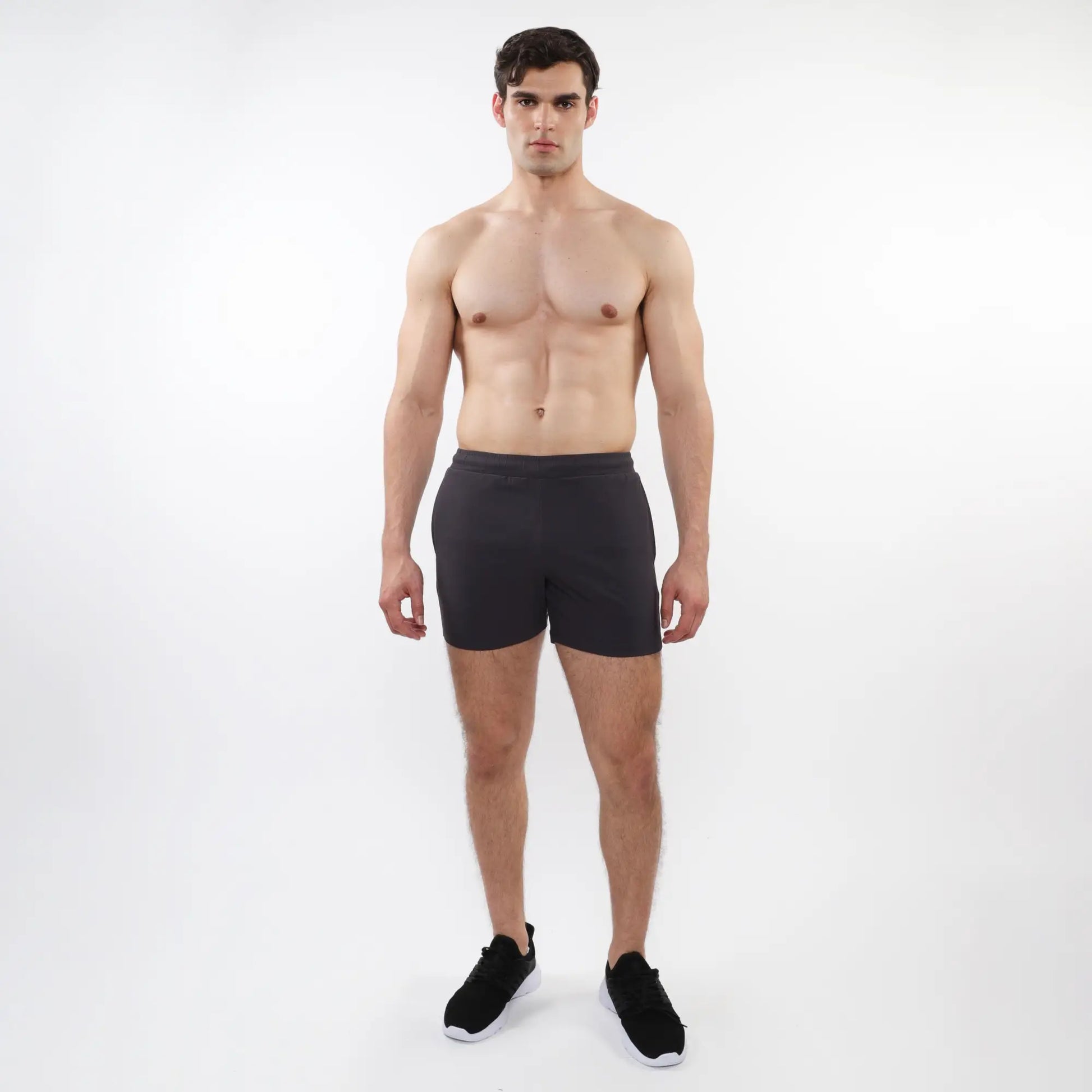 Black textured mesh stretch performance shorts with sleek form-fitting design and elastic waistband for athletic use