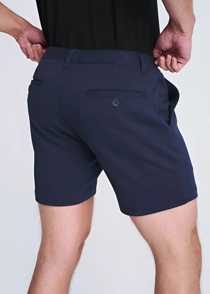 Dark navy blue textured stretch knit chino shorts with tailored fit and subtle button detail on back pocket showing back side