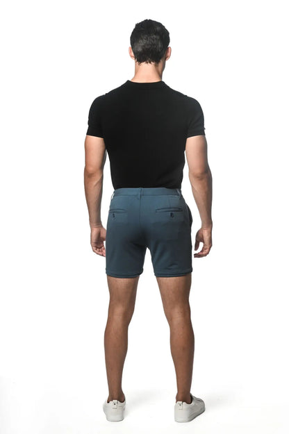 Dark teal textured stretch knit chino shorts with subtle gradient fade and two back pockets shown from the back side