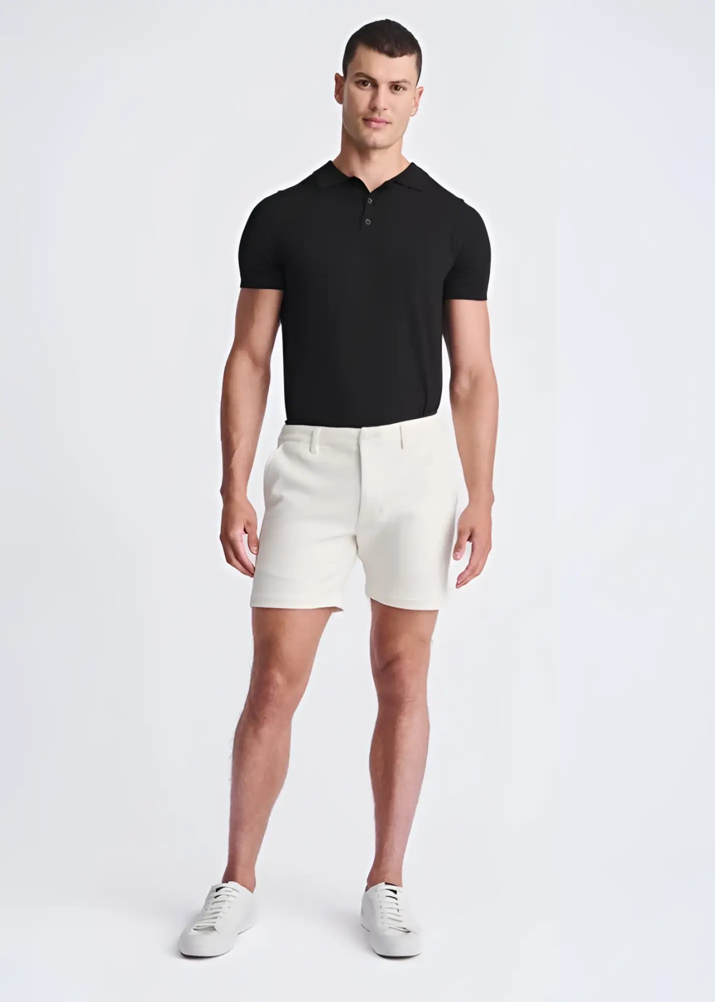A pair of crisp white textured stretch knit chino shorts with a tailored fit and belt loops