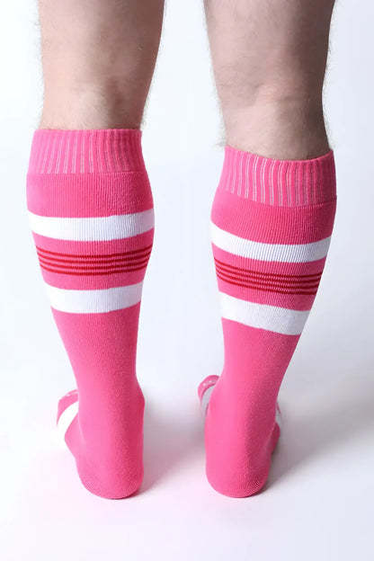 Bright pink tight end knee high socks with white and red striped bands designed for athletic wear
