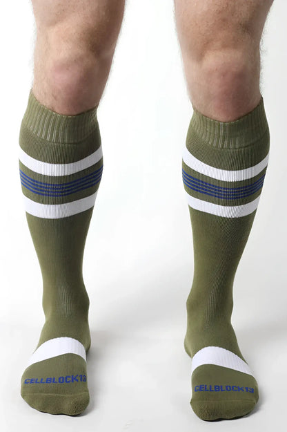 Olive green tight end knee high socks with white and navy stripes ribbed cuff and toe band