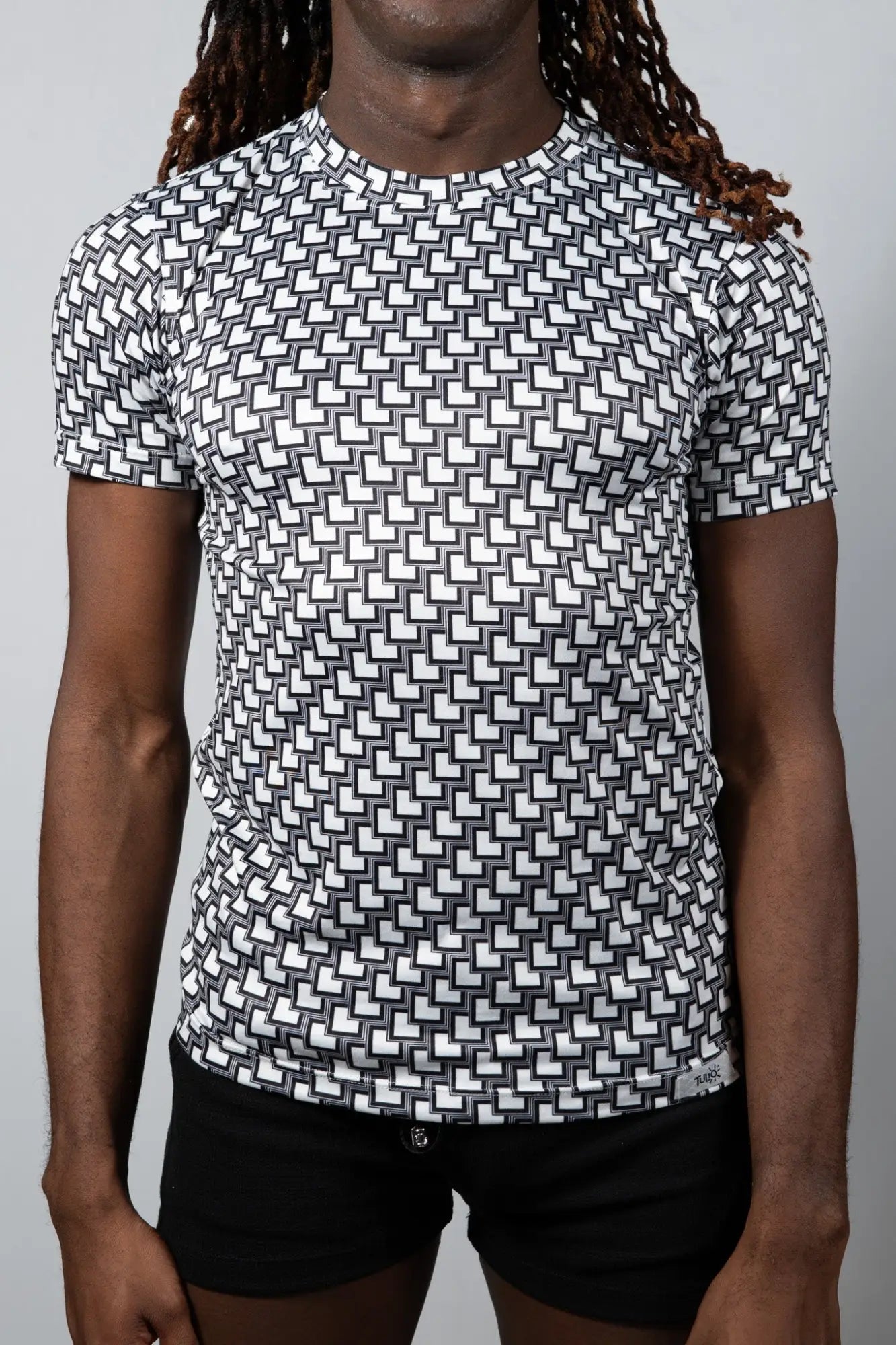 Black and white geometric-patterned short-sleeve rash guard tile print tee for sun protection and water sports