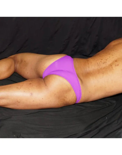 Purple micro bikini underwear by Arroyman featuring a minimal coverage design shown on a model against a dark background.