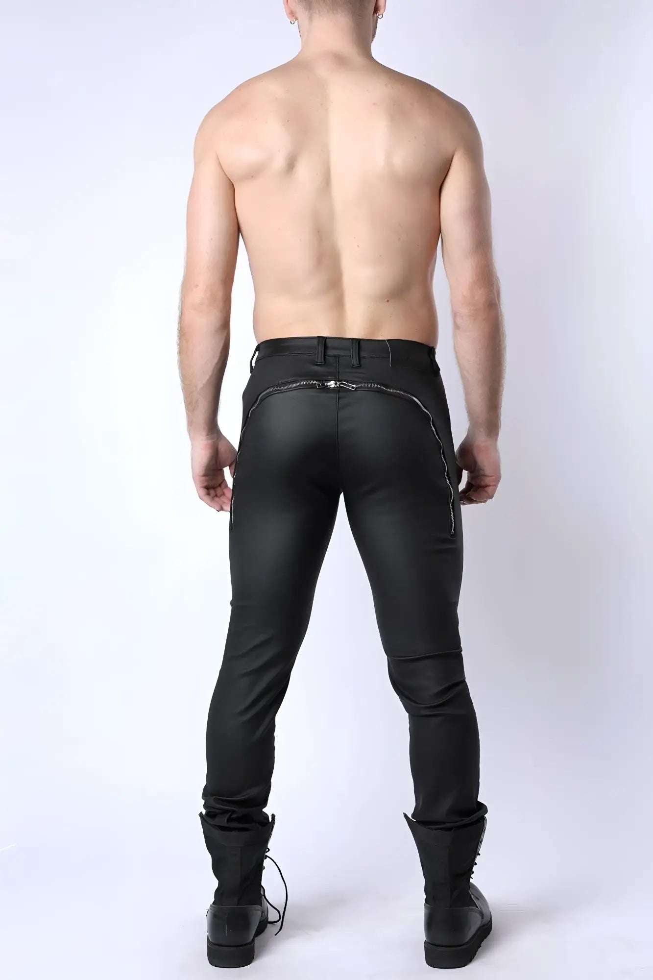 Black leather toro zipper pants with a sleek form-fitting design and silver zipper accents on the back seam
