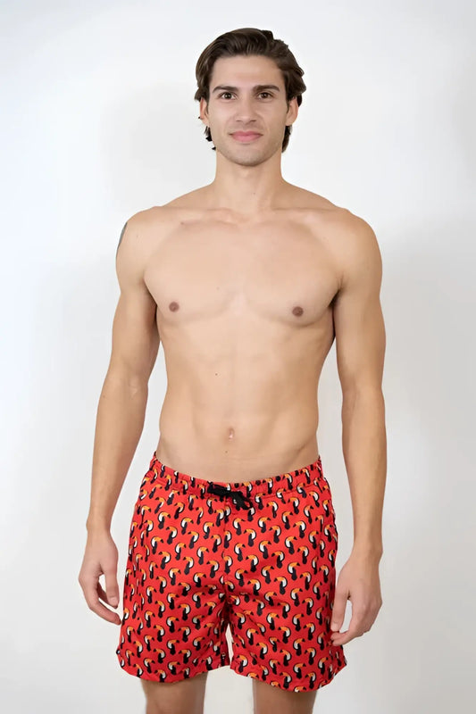 Toucan print swim short featuring red swim trunks with a black and yellow abstract pattern for beachwear