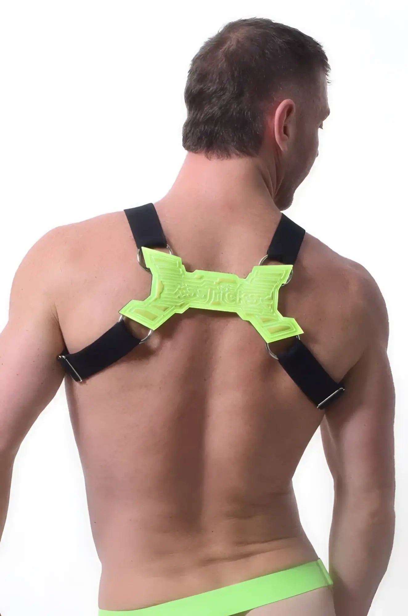 Neon green x-shaped back support with black straps on the back side of transistor harness for posture correction