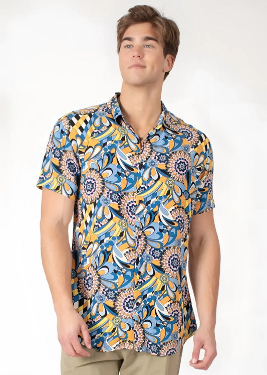 A vibrant blue and yellow floral-patterned tropical abstract short-sleeve button-up shirt with a classic collar