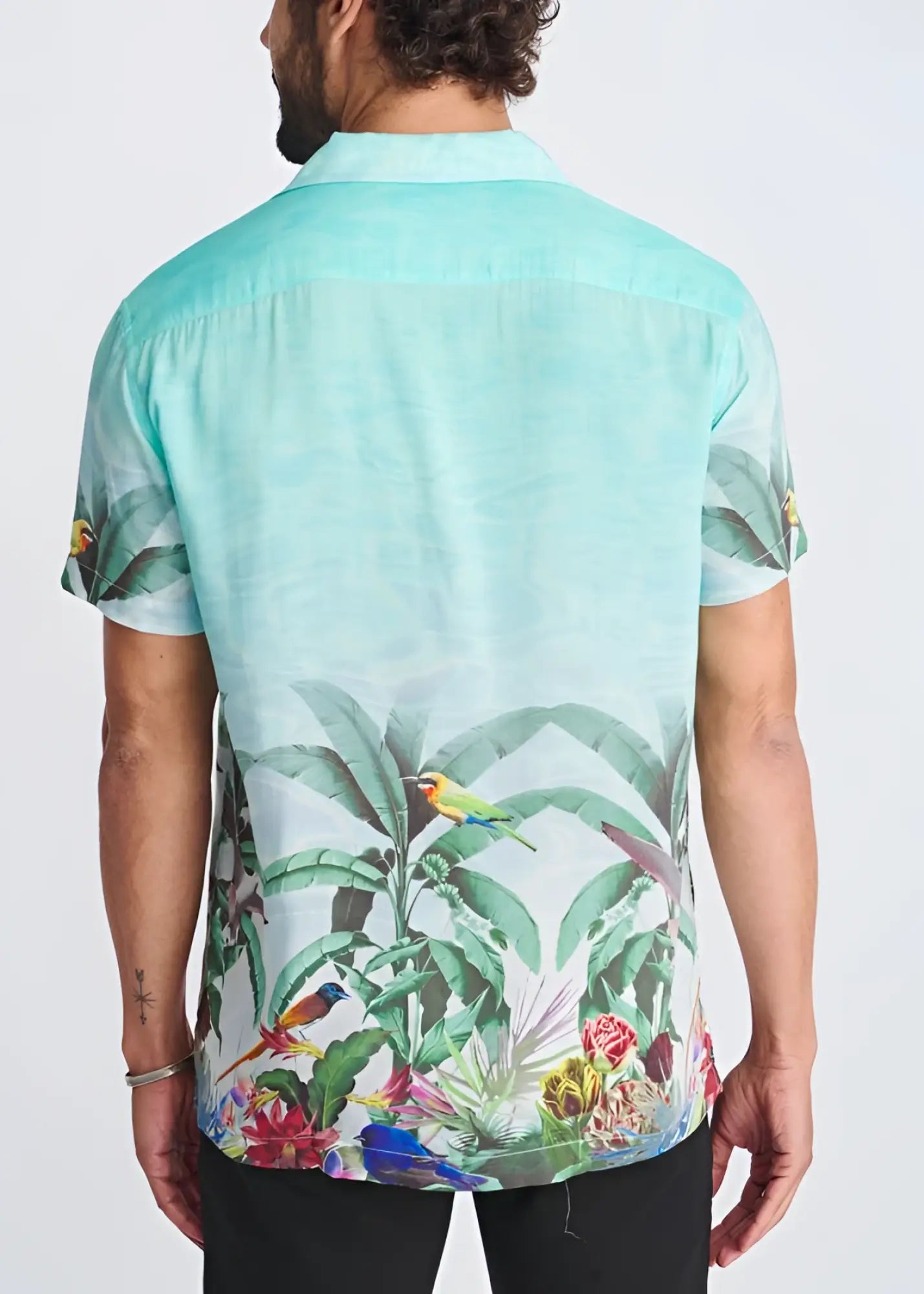 A vibrant mint green tropics border print short-sleeved modal shirt with colorful birds and lush foliage