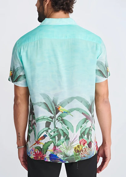 A vibrant mint green tropics border print short-sleeved modal shirt with colorful birds and lush foliage