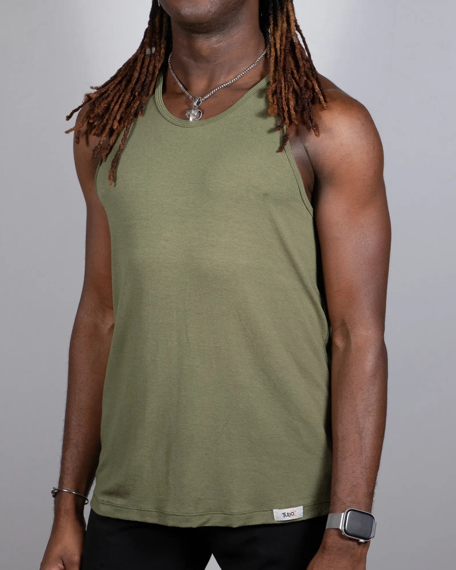 Olive green tulio solid tank sleeveless top with round neckline and white brand tag at bottom hem