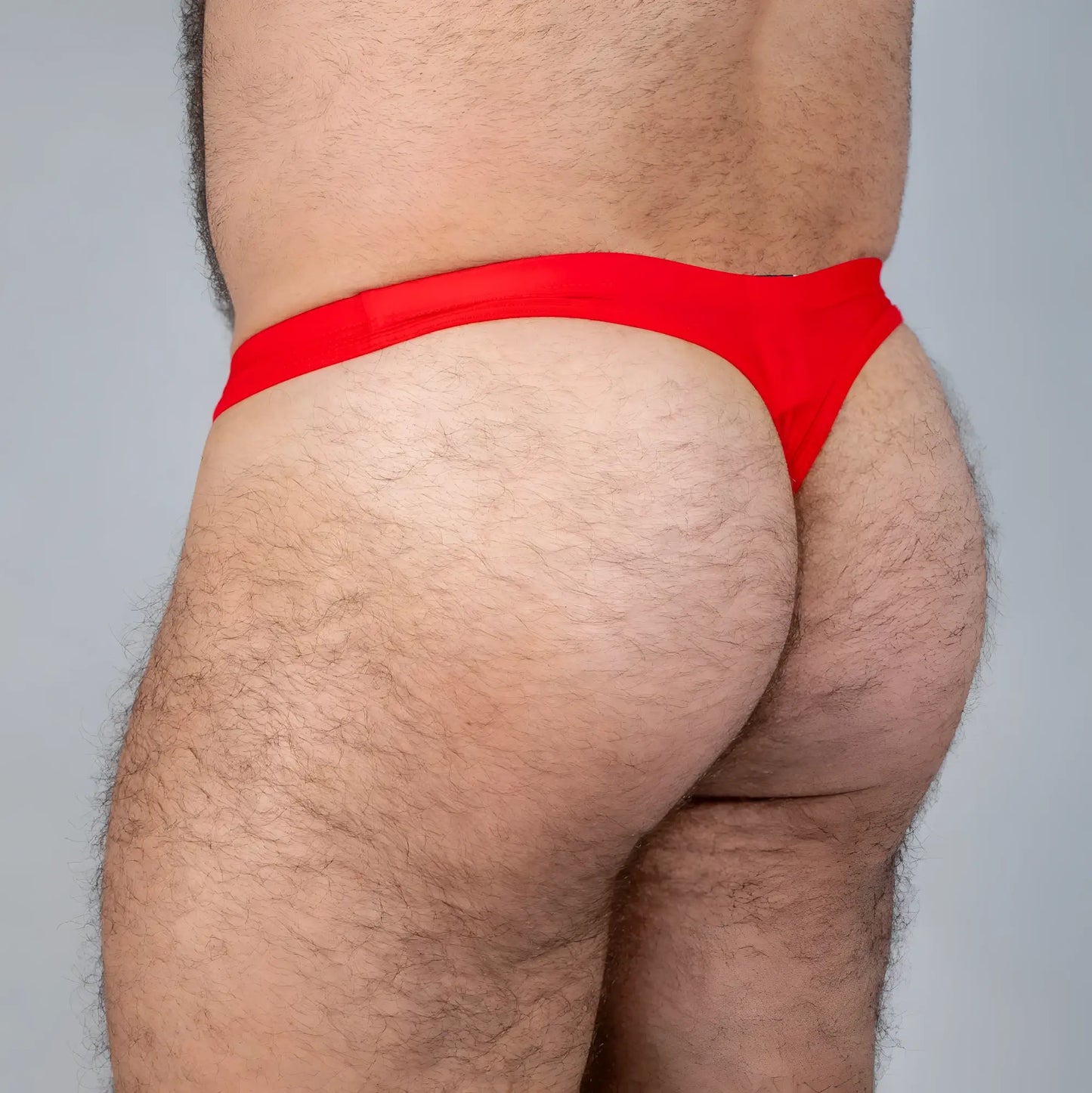 Bright red Tulio swim thong made of smooth stretchy fabric for comfortable beachwear use