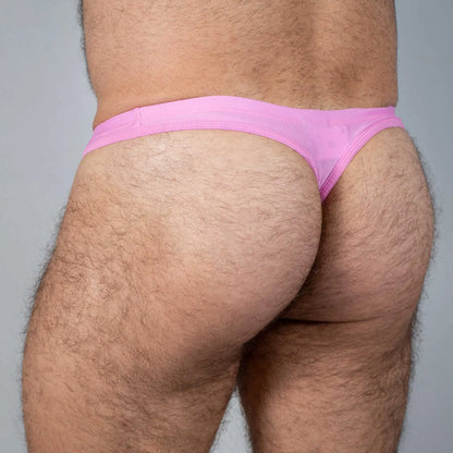 Pink tulio swim thong made of sheer fabric featuring solid color design shown from the back side