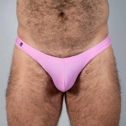 Pink tulio swim thong made of smooth stretchy fabric with a small black brand tag on the waistband front side