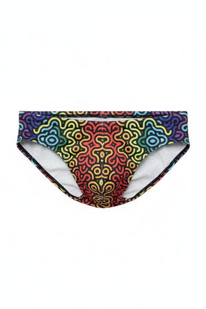 Flat lay of a swim brief with a black background and a colorful, swirling rainbow maze pattern.