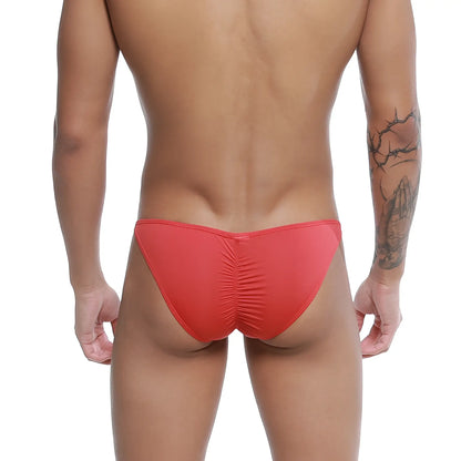 Red form-fitting u-station me bikini swim trunks with ruched back design shown from the back side