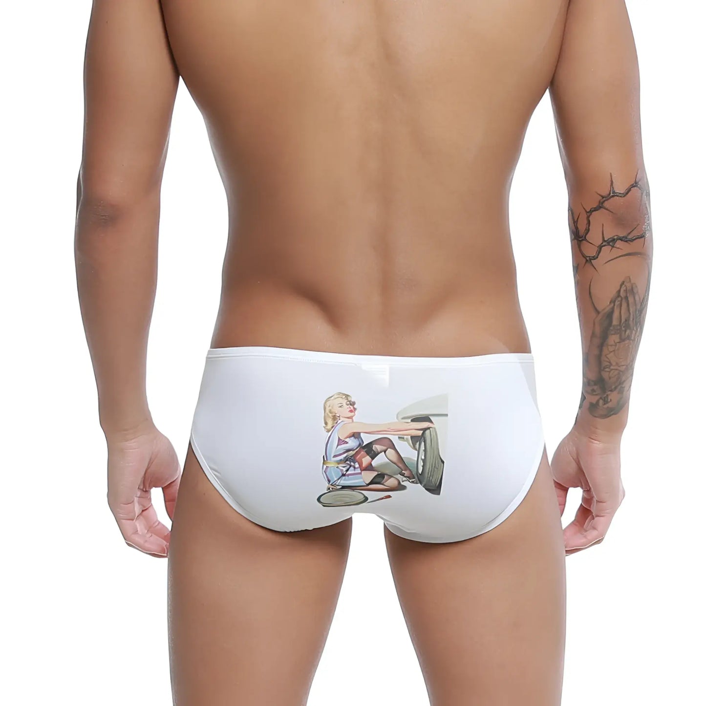 White swim trunks featuring a vintage illustration of a blonde woman in a retro outfit repairing a car wheel.