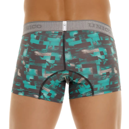 Teal and black pixelated patterned men’s boxer briefs with gray elastic waistband featuring Unico branding