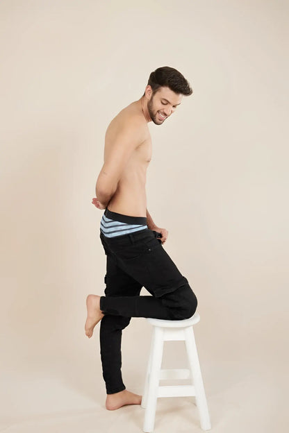 Black denim Unico Espectaculo trunks with turquoise striped waistband showing front side details