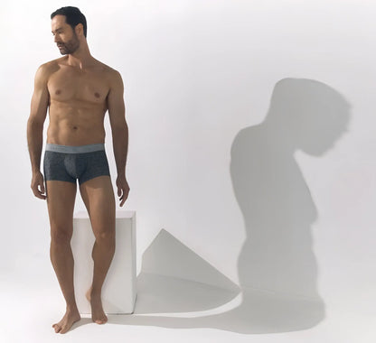 Dark gray calvin klein chiseil trunks with a light gray waistband featuring the calvin klein logo