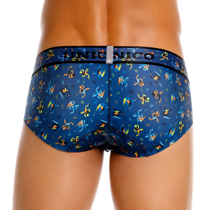 Blue patterned men’s briefs with vibrant orange and yellow stylized figures on dark fabric unico 25060101106 pacer briefs