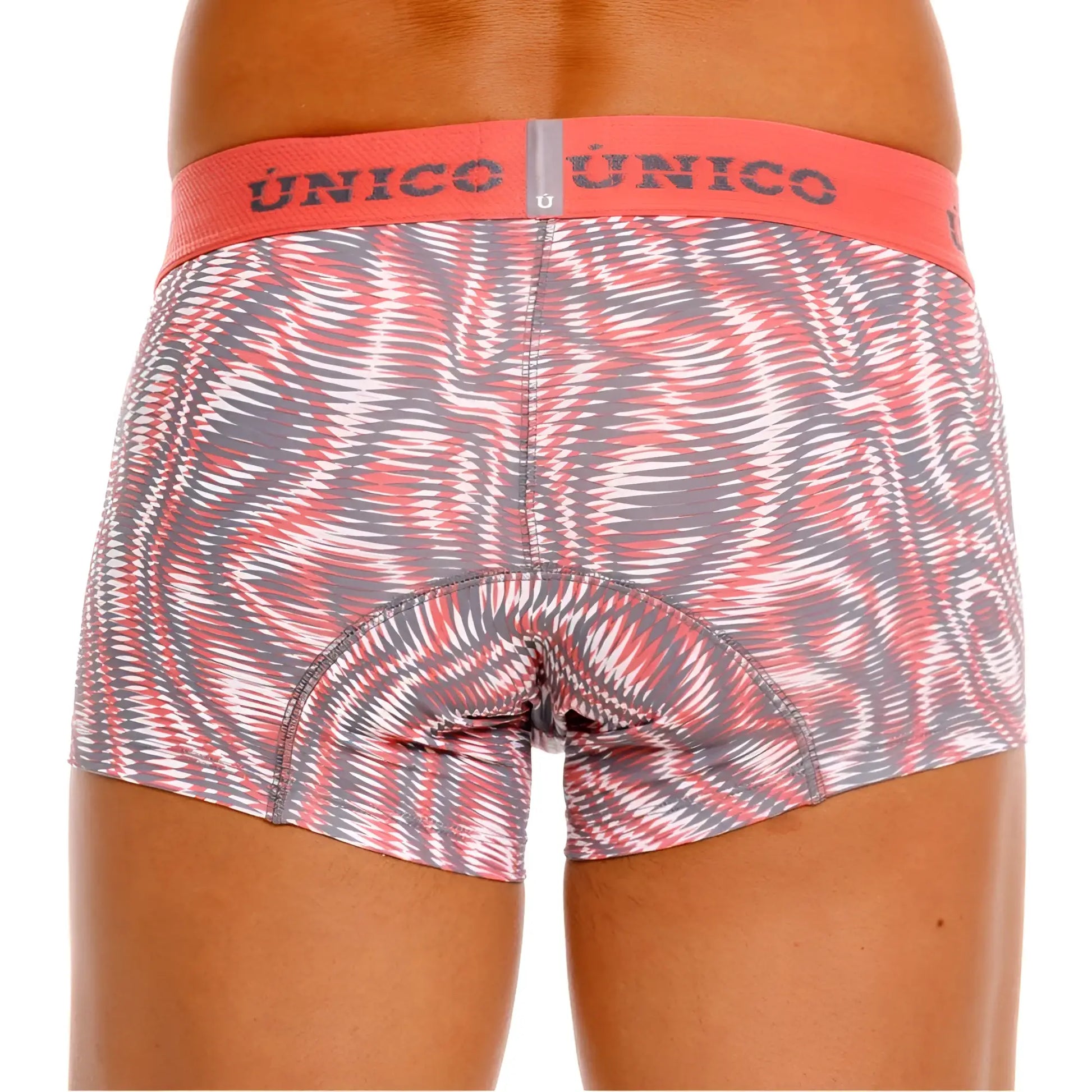 A pair of unico 26020100116 acanalado trunks in pink with a dynamic swirl pattern and orange waistband for men