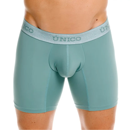Teal-colored form-fitting ceramic boxer briefs with textured gray waistband featuring único brand logo color 43-green