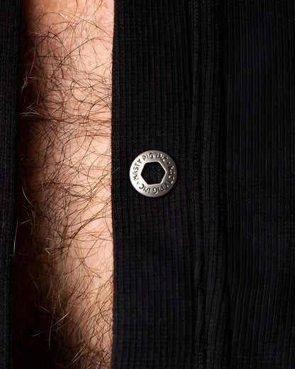 Union suit featuring a silver-toned hexagonal snap button engraved with musty pig inc on black ribbed fabric